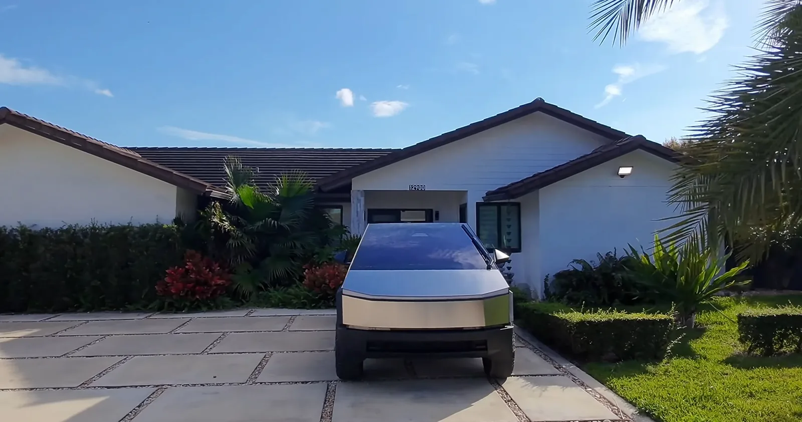 Cinematic shot of a Cybertruck in front of a home